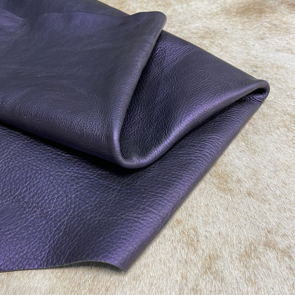 Avetcoinc-Hudson Metallic-Royal Purple The Hudson Metallic Collection - a unique style that boasts a distressed look and pearlized finish. The leather has a smooth and silky surface, showcasing an array of vibrant colors that shimmer in the light. This collection features natural drum-dyed leather that is full grain and made from full-hide cowhide. With an average hide size of 18-20 square feet, the leather is 3 ounces thick (1.0 - 1.2mm) with a pearlized natural grain texture. The temper is medium-soft, and the tannage is chrome-tanned.