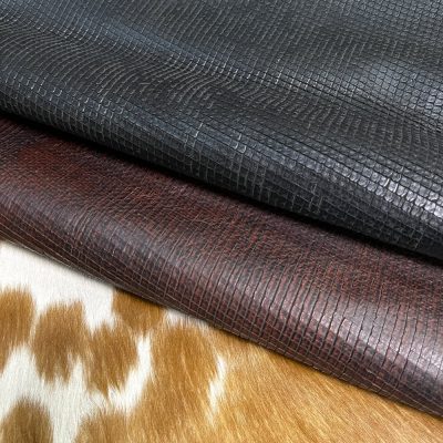 Introducing Alexa Veg Tanned Cow Leather - a special type of leather that is crafted from full grain hide and treated with vegetal tanning. This unique leather boasts a reptile scale-like appearance, but with a more polished and refined look. An aniline finish gives it a waxy, matte texture, while deep grooves outline each square, highlighting their appearance. The squares are also creased, adding texture and definition. The Alexa collection is perfect for various leather needs due to its subtle shine and remarkable design. This leather is made from heifer (double shoulder) and weighs 5/6 oz. (2.2 mm-2.4 mm). It is 100% veg-tanned and dyed through (drum dye). The leather is classified as full-grain with a medium pull-up, has a semi-soft temper, and is sourced from Mexico. The Alexa leather is perfect for crafting straps, handbags, accessories, footwear, belts, and leather crafts.