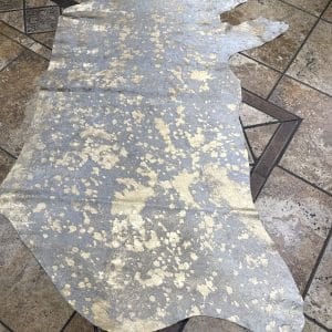 Devore-Gold This stunning hair-on cowhide features a luxurious metallic gold overlay on a natural white base, creating a perfect balance of glam and organic beauty. Ideal for handbags, upholstery, wall art, footwear, and fashion accessories.