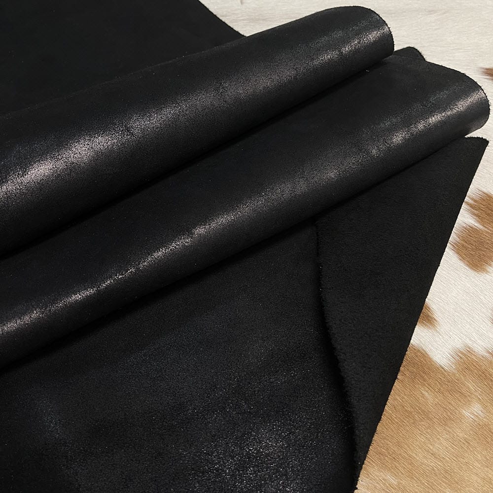 KP.116BLK Y.BOLT (1) The Y. Bolt Cow Suede Collection is a range of leather products that have a unique and rustic appearance due to a combination of special waxes applied on the surface. The leather is tanned using a specific process that involves hot wax application, resulting in a vintage and hip look. The Bolt collection has a subtly shiny and rigid texture that provides a consistent color and design across the surface, making it a durable and attractive leather option for footwear, accessories, handbags, wallets, belts, and more. The raw material used for this collection is cowhide, and the leather is made of cow suede and wax. It has a semi-soft leather temper and a thickness of 1.4-1.6mm, with a weight of 3/4 oz. The average hide size is 17-19 sq. ft., and the tanning process used is chrome tanning. The leather is sourced from Turkey, and it is free of PCP, Azo Pigments, Chrome VI, Formaldehyde, and APEO, ensuring a safe and high-quality product.