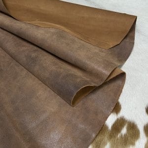 The Y. Bolt Cow Suede Collection is a range of leather products that have a unique and rustic appearance due to a combination of special waxes applied on the surface. The leather is tanned using a specific process that involves hot wax application, resulting in a vintage and hip look. The Bolt collection has a subtly shiny and rigid texture that provides a consistent color and design across the surface, making it a durable and attractive leather option for footwear, accessories, handbags, wallets, belts, and more. The raw material used for this collection is cowhide, and the leather is made of cow suede and wax. It has a semi-soft leather temper and a thickness of 1.4-1.6mm, with a weight of 3/4 oz. The average hide size is 17-19 sq. ft., and the tanning process used is chrome tanning. The leather is sourced from Turkey, and it is free of PCP, Azo Pigments, Chrome VI, Formaldehyde, and APEO, ensuring a safe and high-quality product.