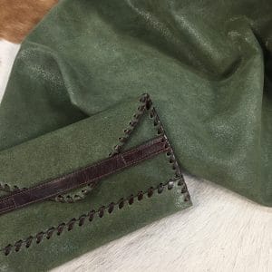 KP.Y.JELLY. B.GREEN (3) The Jelly Cow Suede Leather Collection features high-quality products made from European cowhide treated with a glittery surface. The leather has a smooth suede texture in one direction and a coarser texture in the other, perfect for creating unique textures. Its shimmery yet subtle exterior creates a modern and chic look, ideal for footwear, garments, accessories, and more. The collection is made in Turkey using chrome tanning, which requires fewer chemicals and produces a more consistent color. It's free of harmful chemicals like PCP, Azo Pigments, Chrome VI, Formaldehyde, and APEO. This collection is perfect for those who value quality, style, and durability.