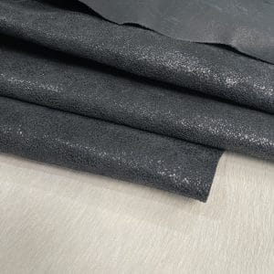 Oklahoma Black The Oklahoma collection leather is not just about its unique crackle finish and vintage look. It's also a testament to durability. Crafted from chrome-tanned heifer hide, it's been dyed-through to create a soft, suede base with a shiny wax transfer on top. This gives the leather a vintage, yet timeless look that's perfect for a variety of uses, including accessories like handbags, wallets, belts, and footwear. Its textured and strong appearance is a clear indication of its durability, making it an excellent choice for apparel and trim. The leather has an aniline finishing which gives it a rugged appearance. It is available in a weight of 3 oz. (1.2-1.4 mm) and has an average hide size of 22-25 Sq. Ft. It is tanned in Mexico and has a soft temper with a dull shine.