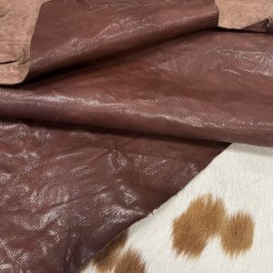 SL-209BRA Brandy Goat 2 The Goatskin-washed Leather Collection offers an exclusive range of leather that undergoes a special tanning process, resulting in a unique and irregular texture. The leather's shrunken grain creates a striking and dynamic appearance, while its distressed look adds to its appeal. The thickness of the leather adds to its durability and dependability. The collection features a variety of warm and distinct colors that make it ideal for creating timeless looks.
