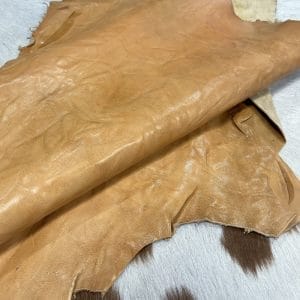 SL-209NUG Nugget Goat 2 The Goatskin-washed Leather Collection offers an exclusive range of leather that undergoes a special tanning process, resulting in a unique and irregular texture. The leather's shrunken grain creates a striking and dynamic appearance, while its distressed look adds to its appeal. The thickness of the leather adds to its durability and dependability. The collection features a variety of warm and distinct colors that make it ideal for creating timeless looks.