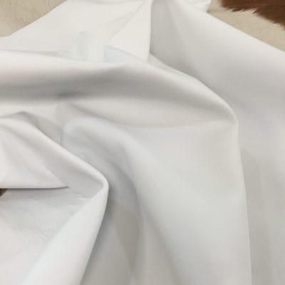 Lambskin Leather Grade C is a type of leather that might have some imperfections, but they do not affect its performance. Instead, these flaws give it a unique appearance. The leather's raw material is sourced from sheep or lamb, and it weighs 2 oz. with a thickness of 0.7-0.9 mm. Furthermore, the economy grade Lamb leather may have uneven shade tone, dark spots, stretch marks, scarring, scratches, or a few holes. However, these flaws do not affect its performance. Instead, they give it a unique appearance that sets it apart from other types of leather. The leather has a semi-gloss finish, which adds to its aesthetic appeal. Additionally, its soft-medium temper makes it pliable and easy to work with. In terms of size, the average hide size for economy grade Lamb leather is 6-8 sq. ft. With this size, you can use this type of leather for making accessories, arts and crafts, shoes, apparel, and more. Its versatility and unique appearance make it an excellent choice for various projects.