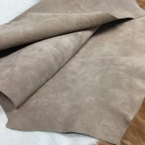 hognubuck_taupeAvetcoinc@ (1) This exquisite collection features Pigskin Nubuck Leather, a suede with utmost softness that adds sophistication to any outfit. The timeless palette of natural colors perfectly complements the eye-catching hues, offering a versatile range of options. The suede's supple texture is incredibly tempting to the touch, and the leather comes from domestic pigs processed as whole hides with a thickness of 3 oz and an average size of 5-6 sq. ft. Additionally, the nubuck texture and medium soft temper of the suede perfectly highlight its exquisite suede texture. The leather is tanned using the chrome tannage method and is sourced from Taiwan. This exquisite collection is worth checking out, Perfect for footwear, accessories, handbags, apparel, belts, and DIY projects. What is Nubuck Leather? Top Grain Leather whose surface has been buffed and brushed to create a soft, velvety effect. Differs from suede in that while suede is created from the flesh (inner) side of a hide, nubuck is created using the grain (outer) side, giving it added strength and durability. You chose this leather because of its natural beauty, soft hand, and luxurious feel. Through years of experience, we have developed unique ways to maintain and protect these naturally tanned leathers. The lack of a coated finish requires special attention. What is Nubuck Leather?