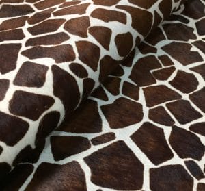 Cow Hair On Giraffe-Chestnut This chestnut cowhide features a bold giraffe print, offering a unique, exotic touch to any project. Perfect for handbags, upholstery, footwear, garments, pillows, and décor. Printed on premium hair-on cowhide for durability and natural texture with a wild, stylish edge. Each hide is one-of-a-kind—ideal for standout fashion and interior designs.