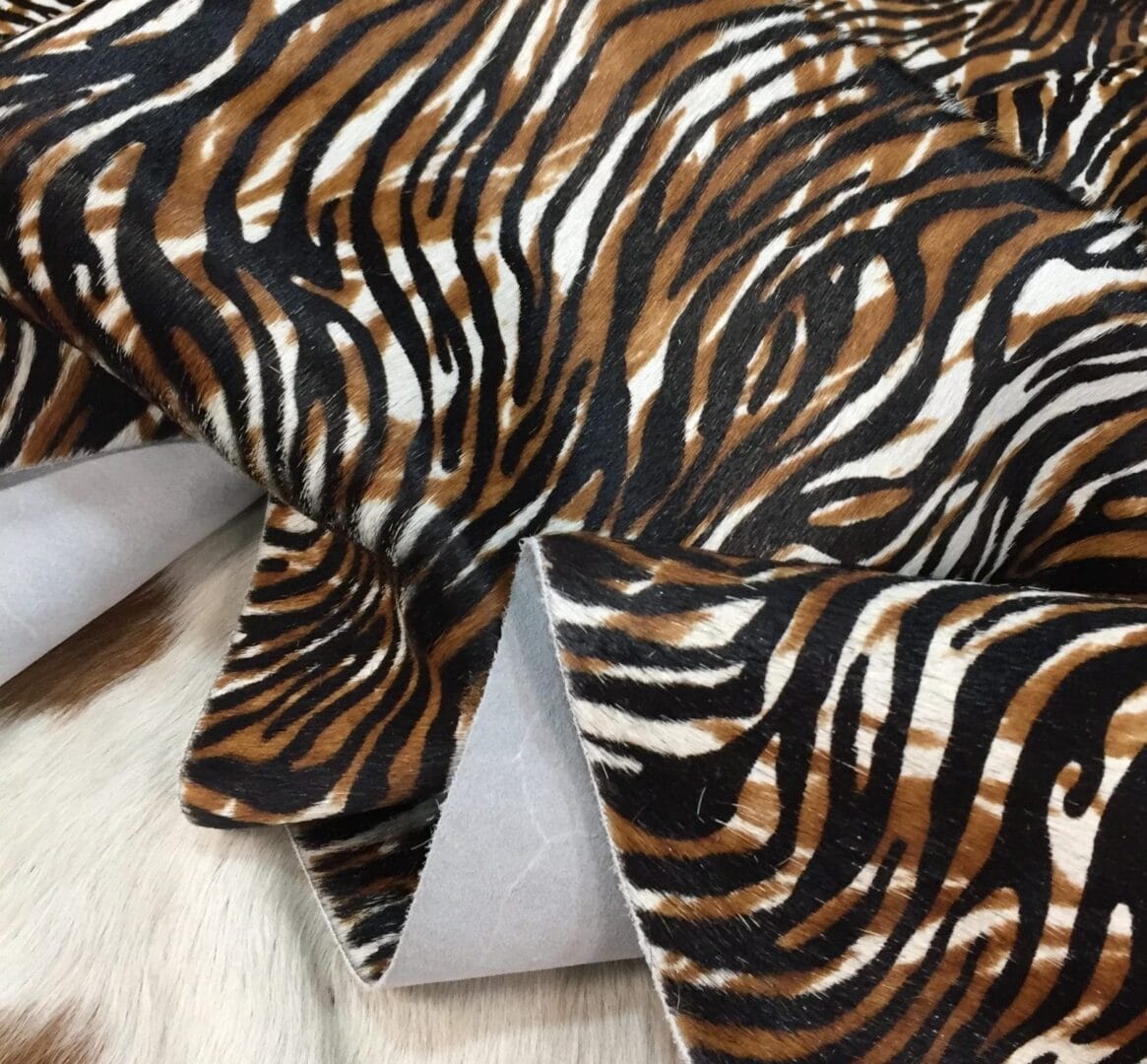 Avetco Inc-Cow Hair On Zebra Print Black with Brown (3) Cowhide with striking black and brown zebra print. Ideal for handbags, shoes, garments, upholstery, pillows, and décor. Natural, bold, and stylish finish.
