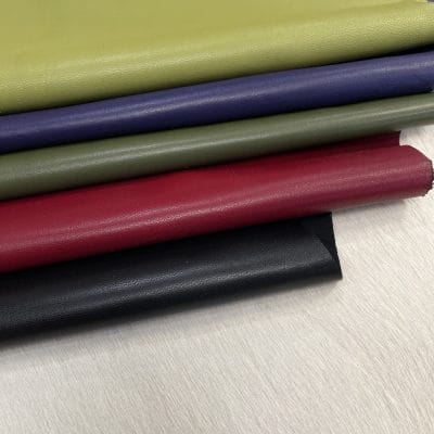Heritage Goatskin Leather features a silky smooth texture and a refined finish. Available in rich shades of red, black, green, and purple, it offers durability and versatility for bold, sophisticated designs.