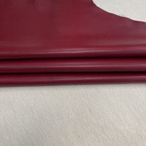 SL-200COR Cordova Red 1 Heritage Goatskin Leather features a silky smooth texture and a refined finish. Available in rich shades of red, black, green, and purple, it offers durability and versatility for bold, sophisticated designs.