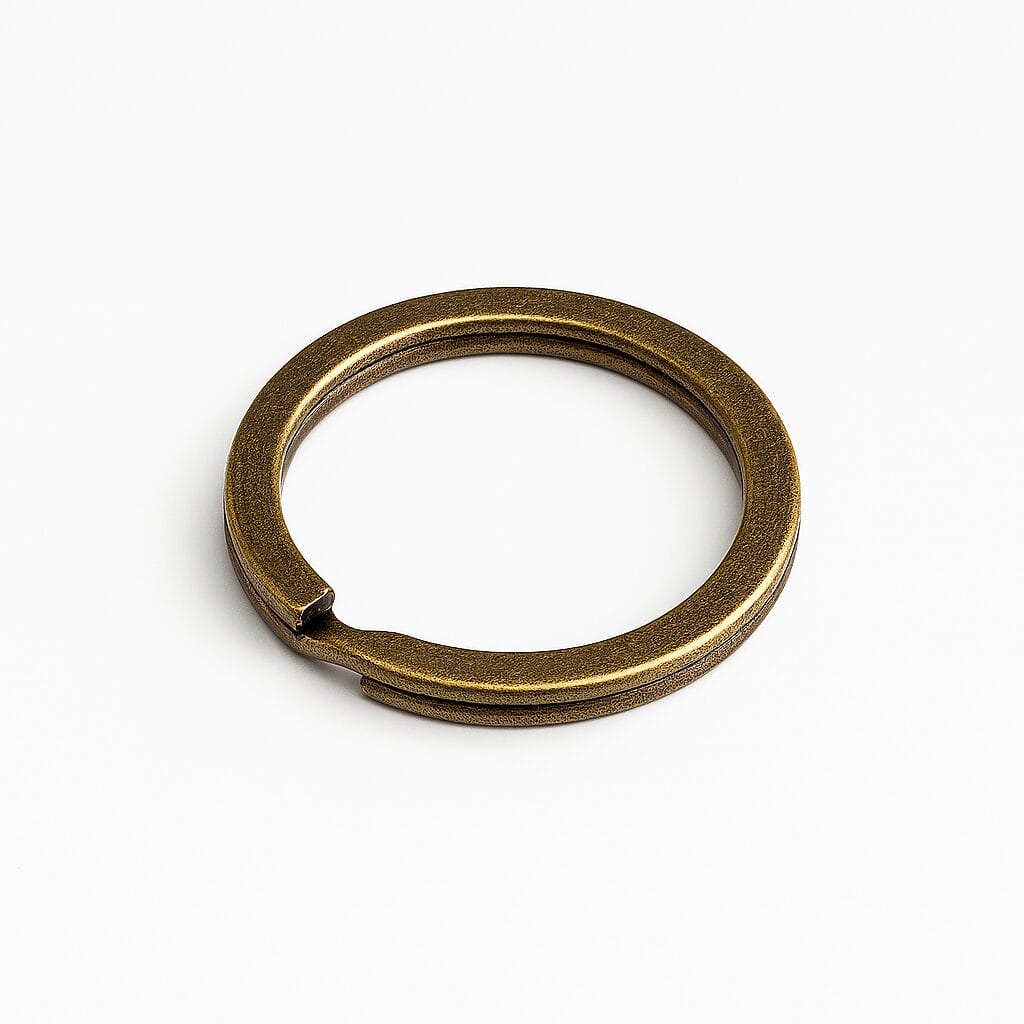 Antique brass split key ring on a white background.-Avetco