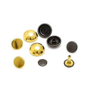 Gold and gunmetal dome rivets displayed side by side on a white background, showcasing color variation and reflective metallic finishes.