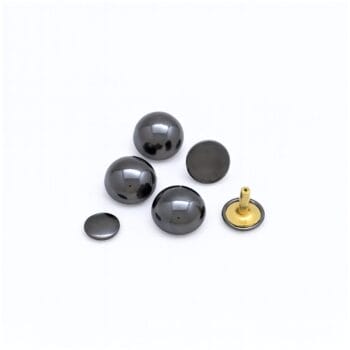 Shiny gunmetal dome rivets displayed on a white background, highlighting smooth dark gray reflective surfaces with brass posts.