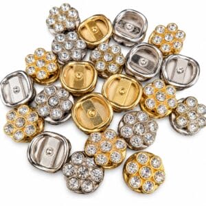 A pile of Gold and Nickel AK298 rhinestone flower slides