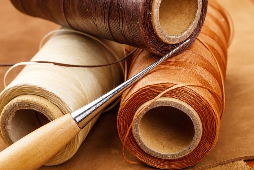 Waxed thread spools and needle