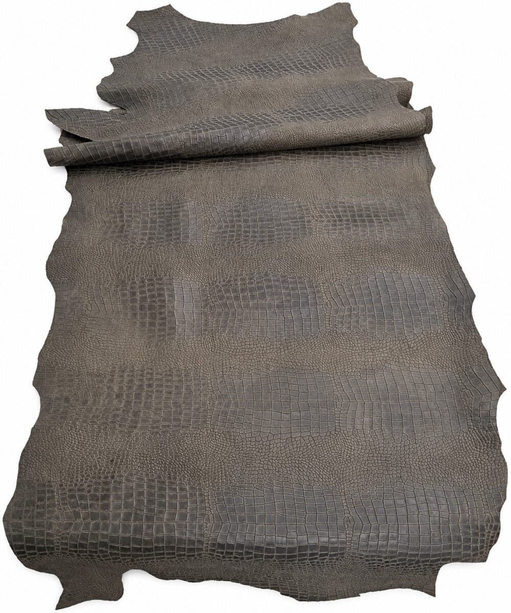 black olive escape alligo cow leather crocco belly embossed side hide Brown crocodile/alligator leather hide with textured scales laid flat, rolled at the top edge