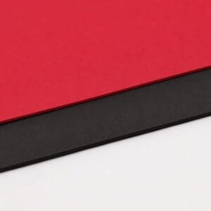 Close-up of diagonal red, black, and white color bands forming abstract stripes.