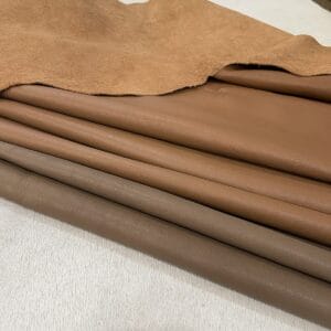 Tan and taupe full grain cow leather sides stacked Tan and taupe full grain cow leather sides stacked