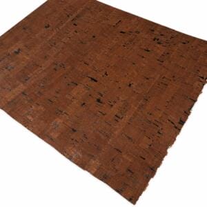 Brown cork tile with natural grain and small black flecks on a white background