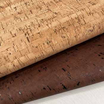 Rolled cork flooring samples in light and dark finishes on a light surface.