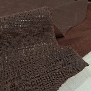 Brown linen embossed cow leather close-up of the woven texture