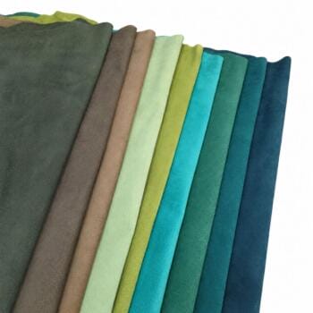 Row of folded fabric swatches in shades from dark green to navy, arranged in a curved fan pattern on a white background.