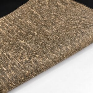 natural cork fabric meadow Rolled brown cork fabric with a speckled, textured surface on a white background.
