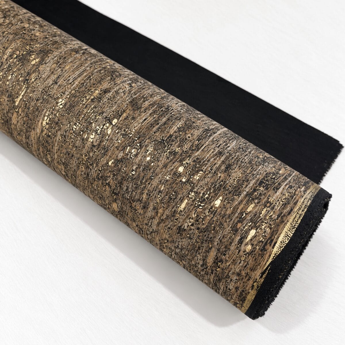 natural cork fabric meadow Roll of cork-textured wallpaper or fabric with brown speckled pattern, partially unrolled on a white surface, showing black backing edge