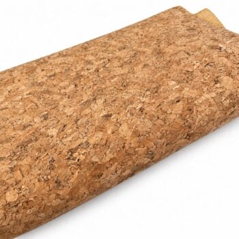 Close-up of a rolled cork sheet showing its natural, mottled brown texture.
