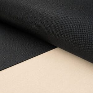 pyramid black large sheet Close-up of black textured fabric rolled over a light wooden surface, showing a fine grid-like pattern.