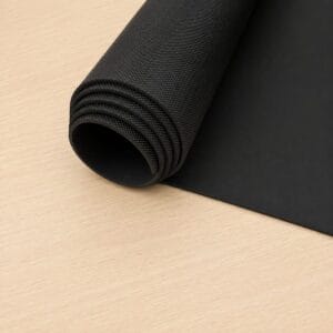 pyramid black large sheet Rolled black yoga or exercise mat on a light wood surface, partially unrolled to show texture.