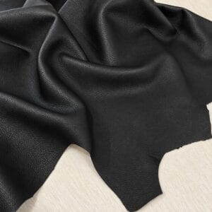 Signature Pebble Lambskin Black Black Signature Pebble Lambskin draped to show the soft tumbled pebble grain