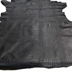 slalligo black Close-up of black crocodile leather texture with raised square scales in a grid pattern, on a dark hide surface.