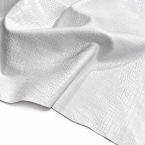 slalligo white Close-up of white snakeskin leather fabric with raised scales and soft folds.