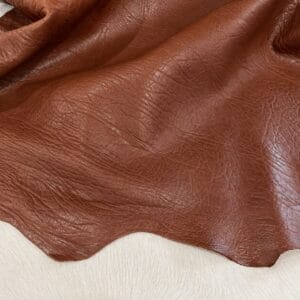 Close-up of brown leather with visible grain and creases.