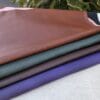 SL-115 stretch lamb SL-115 Stretch Lamb leather hides in rustic brown, polo green, chocolate, and purple velvet colors.