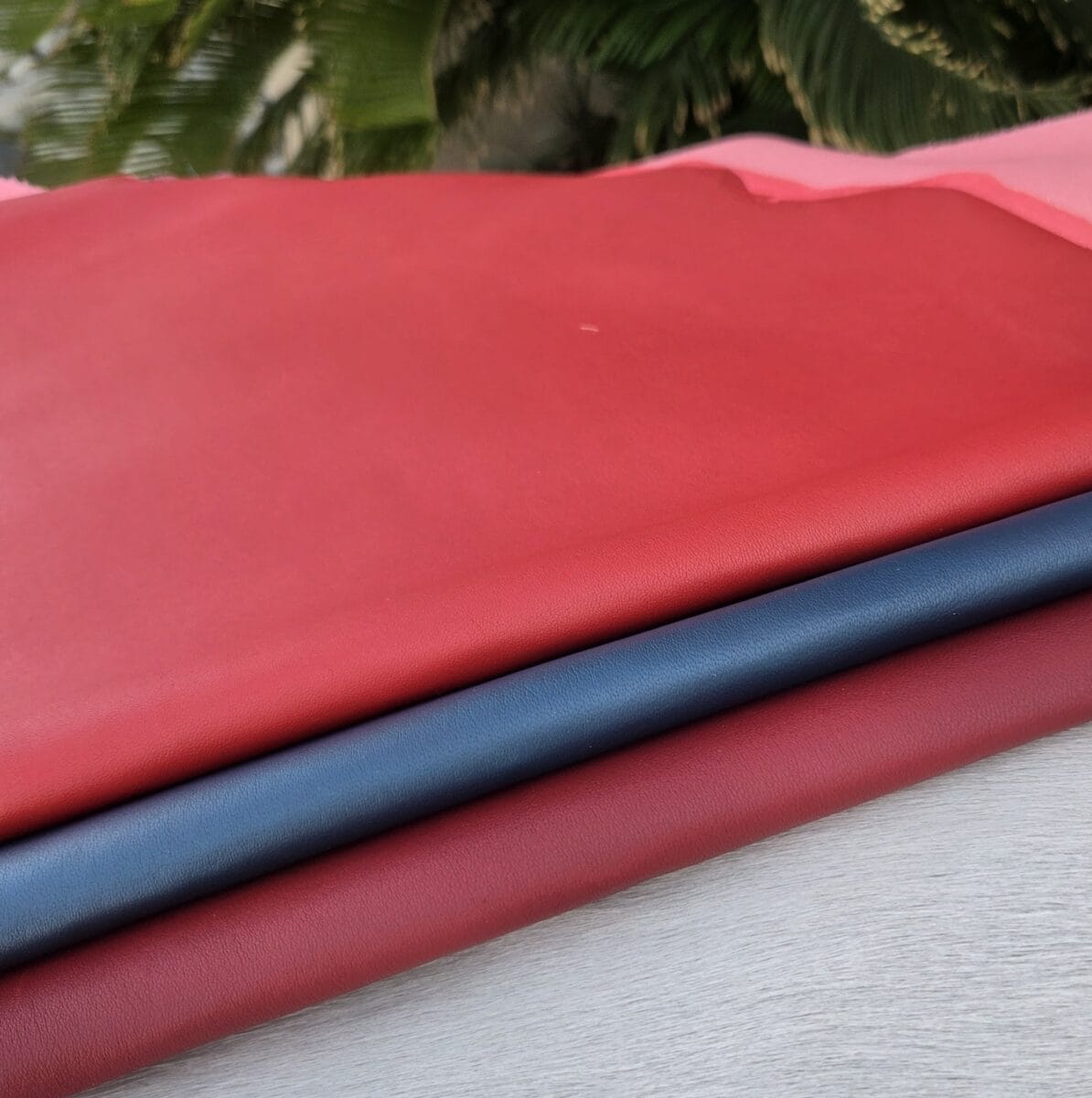 SL-115 stretch lamb Red and navy blue SL-115 Stretch Lamb leather hides displayed together with smooth grain texture.