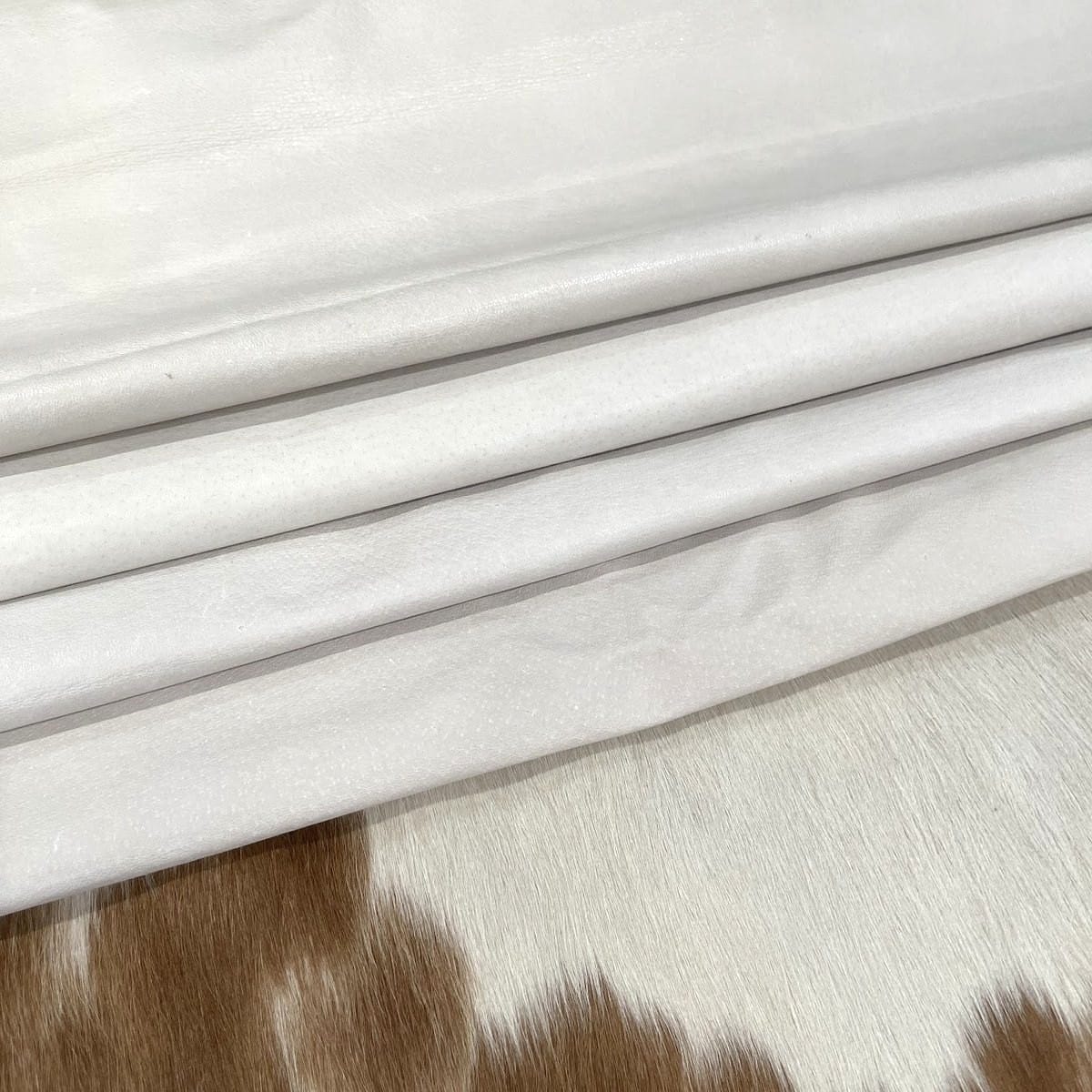 White pig leather hides folded in layers White pig leather hides folded in layers – tannery run half bundle